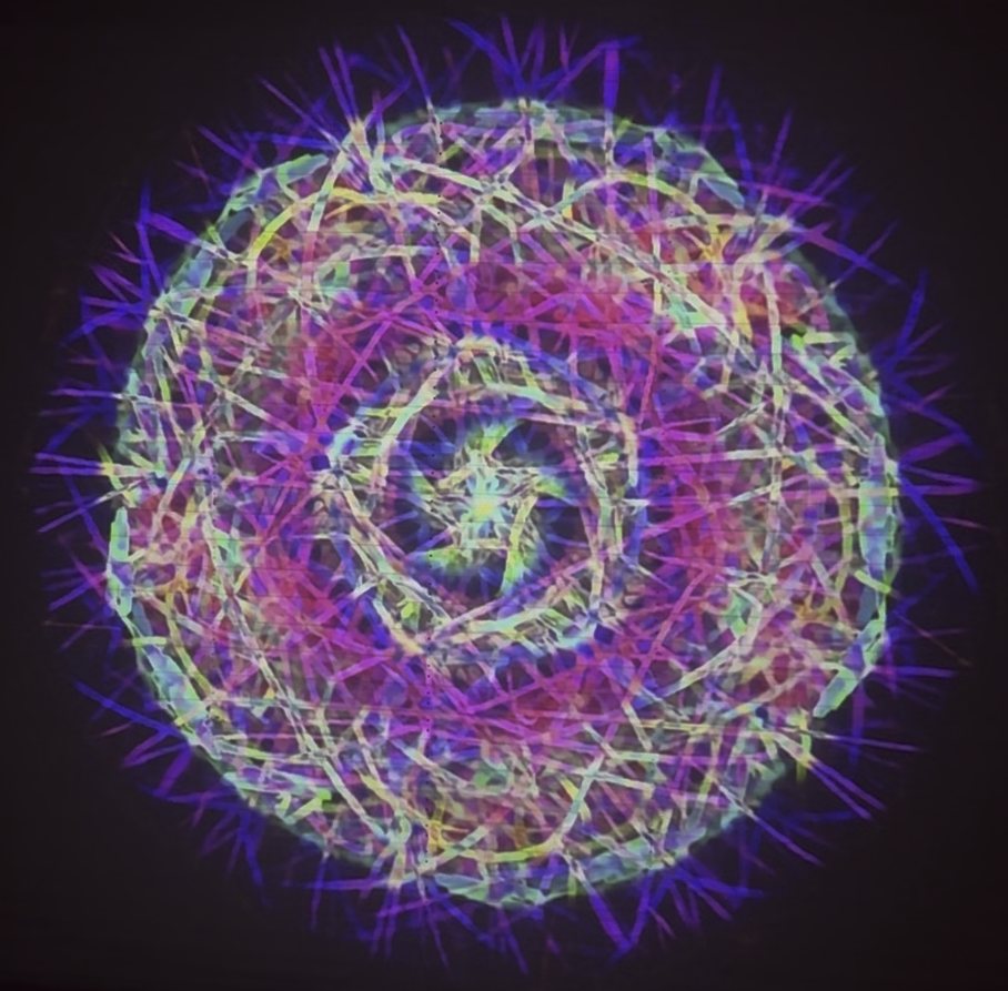God's Eye projected on a wall: a glowing kaleidoscopic mandala of purple, blue and yellow-green light lines